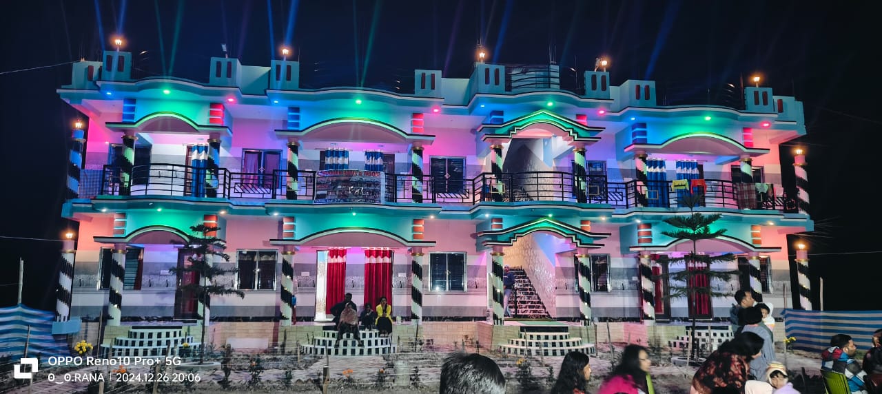 The homestay lit up at night during a celebration