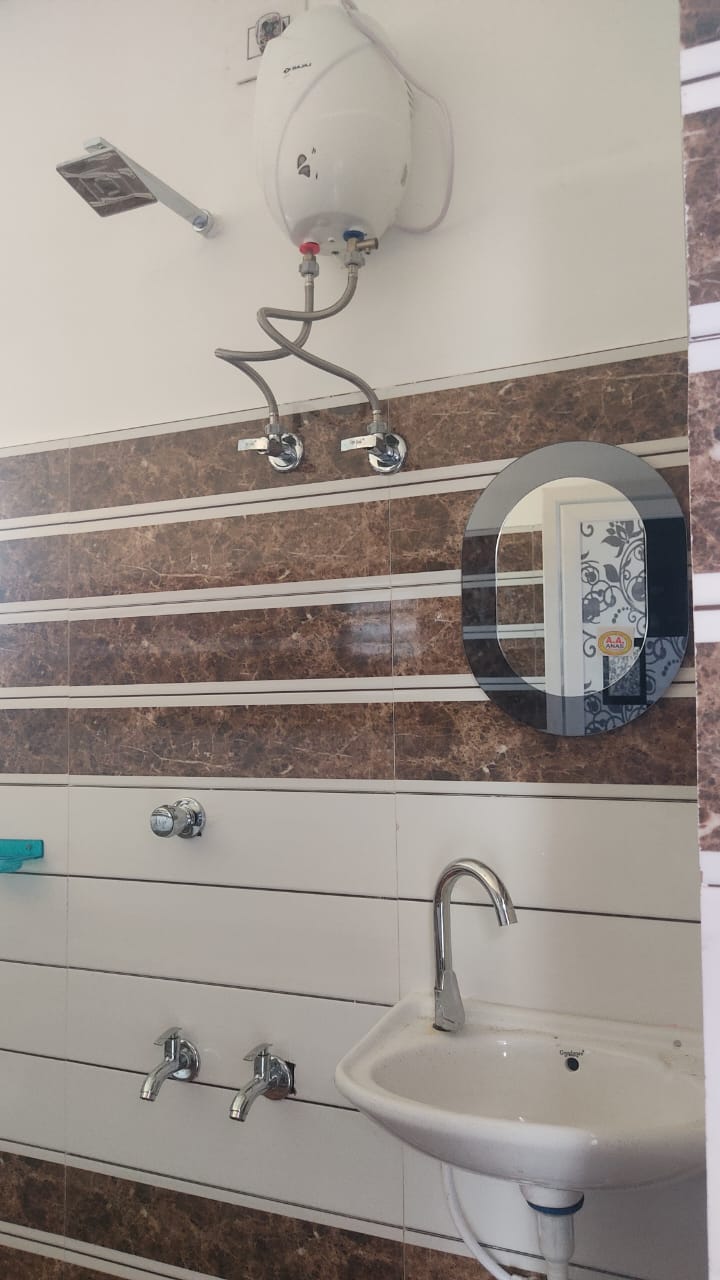 Bathroom with geyser hot water, mirror and wash basin