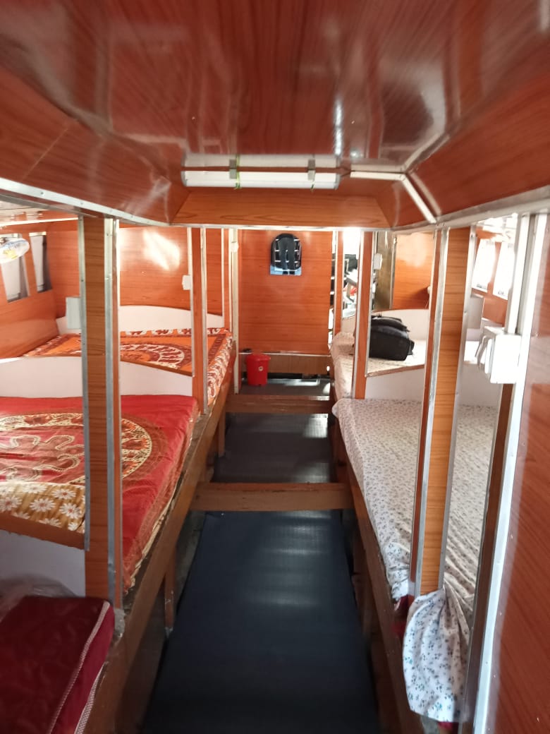 Wooden sleeping cabin inside the boat with bunk beds