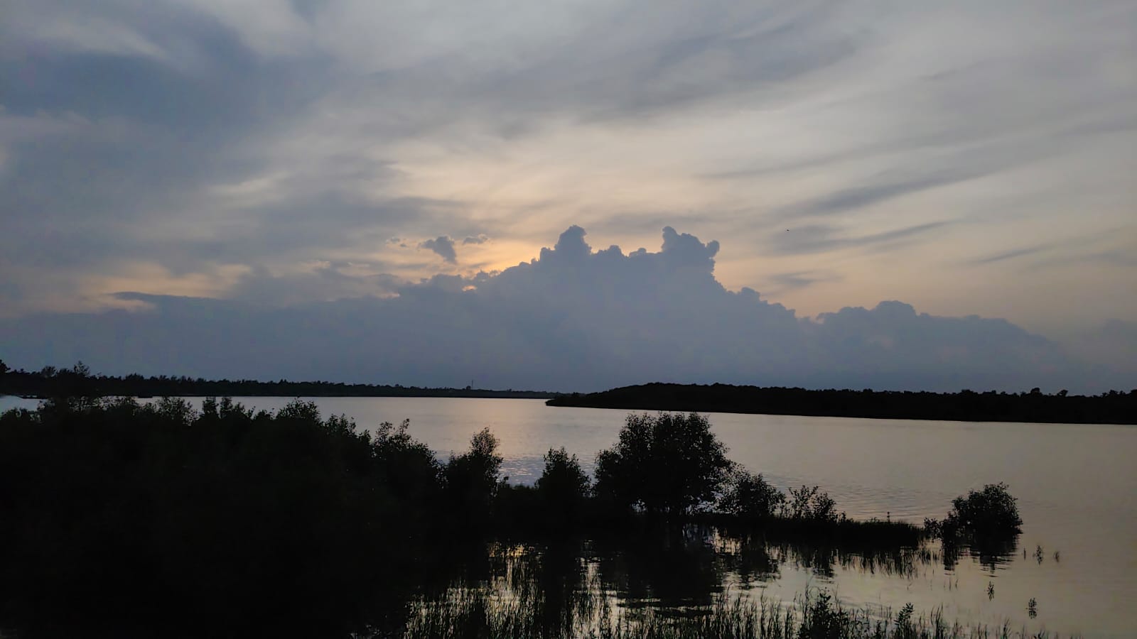 Evening clouds over the wetlands and still water