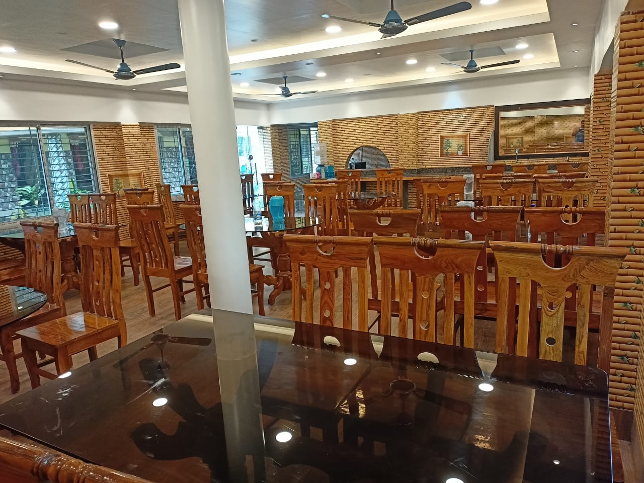 Indoor dining hall with wooden tables and seating for guests