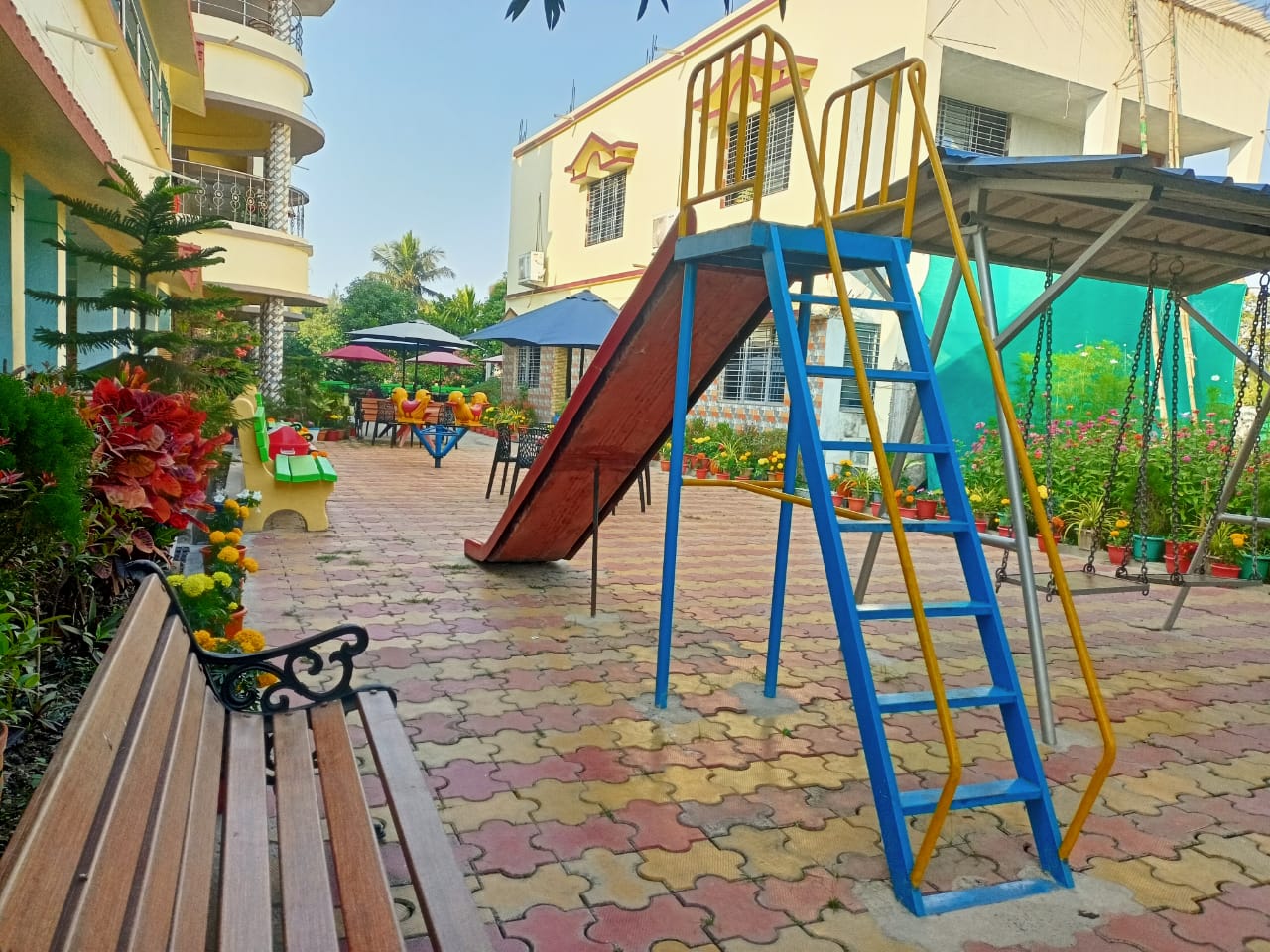 Children's play area with slide and swings beside the homestay